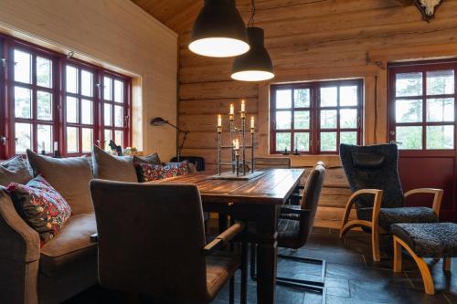 a dining room with a wooden table and chairs at Hot tub | Sauna | WiFi | Pets allowed in Lofsdalen