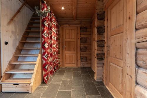 a hallway with a staircase in a cabin with christmas decorations at Hot tub | Sauna | WiFi | Pets allowed in Lofsdalen
