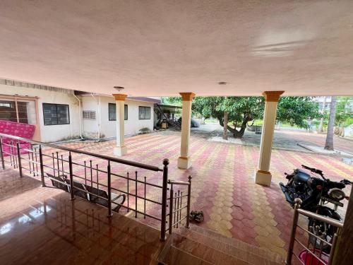 a view of a building with a motorcycle parked in a courtyard at Zeno Villa Malpe - Premium Villa in Malpe