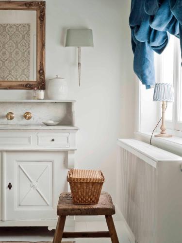 a wicker basket sitting on a stool in a room at Guesthouse Groeninghe in the centre of Bruges in Bruges