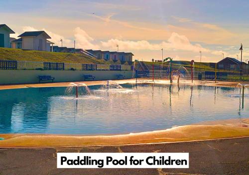 a pool for children with a water park at Romantic Lakeside Cottage by the Beach! with Super Cosy Log Burner! The Perfect Escape to Your Home from Home by the Sea! So Relaxing - You Won't want to Leave! Pet Friendly! in Mablethorpe