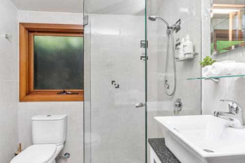 a bathroom with a shower and a toilet and a sink at Cape Byron Suite 5 Private Suite with Ensuite in Byron Bay