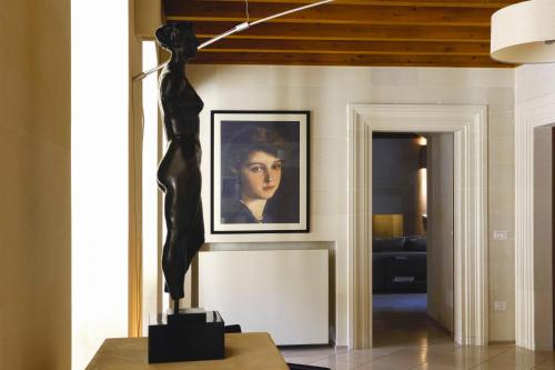 a statue of a woman on a table in a room at La Fiermontina Luxury Home Hotel in Lecce