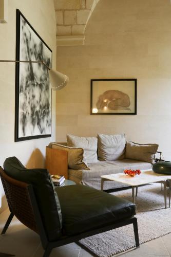 a living room with a couch and a table at La Fiermontina Luxury Home Hotel in Lecce