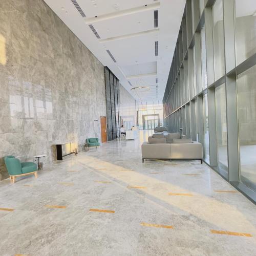 a large lobby with a couch and a fireplace at Marakez Aeon Towers in 6th Of October