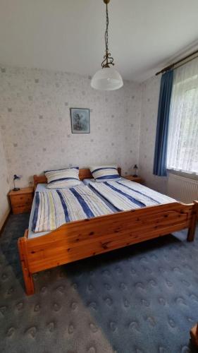 a bedroom with a large wooden bed in a room at Ferienwohnung Hoppenstedt in Winsen
