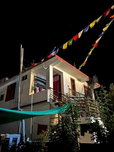 a house with flags hanging from it at night at tabocoffeehouse in Tabo