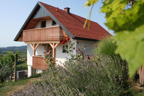 a small white house with a red roof at Rebenchalet in Sankt Anna am Aigen