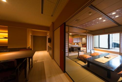 a living room with a table and a couch at Tachibana Shikitei in Kaga