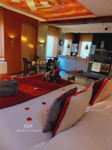 a bedroom with a large bed with red sheets at Le BELLEA in Verviers