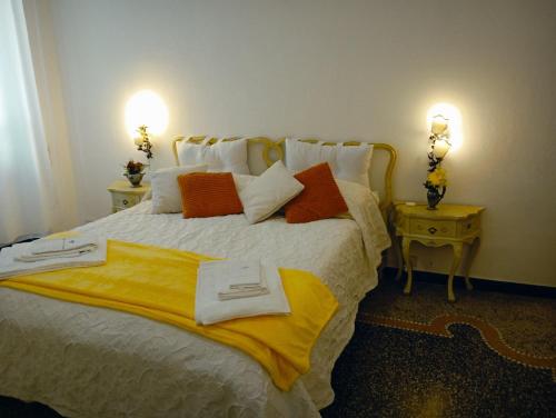 a bedroom with a large bed with two lamps at Small Luxury House in La Spezia