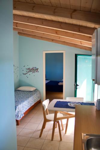 a room with a bed and a table in a room at Kekatos Studios in Lassi