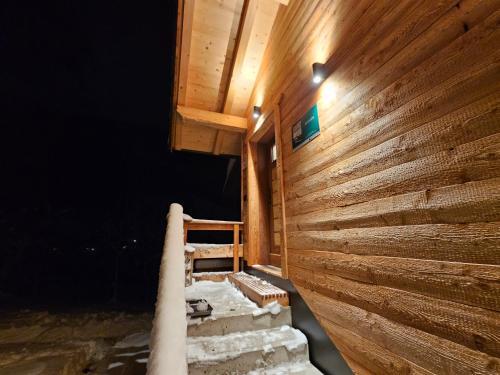 a wooden house with a wooden wall and stairs at Ferienhaus Maria´s Hoamatl in Gallzein