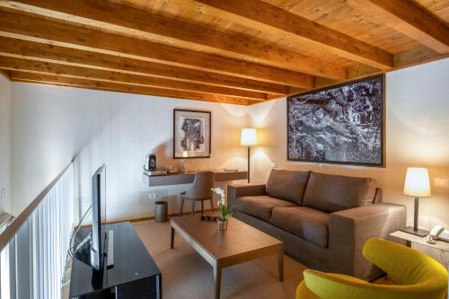 a living room with a couch and a table at La Fiermontina Luxury Home Hotel in Lecce