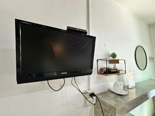 a flat screen tv hanging on a wall at บ้านชวนชมเกาะล้าน in Ko Sak