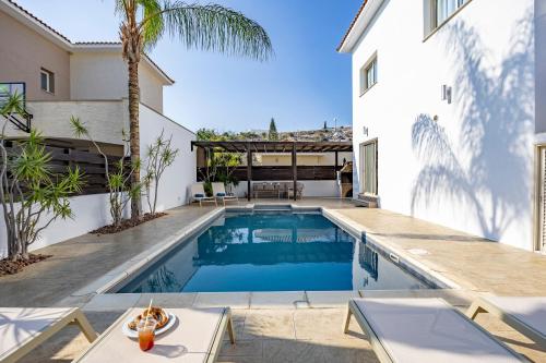 a swimming pool in the backyard of a house at Agios Tychon Luxury Villa with Private Pool in Limassol