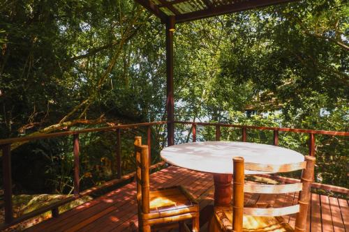 a table and two chairs on a deck at Japamala Resort by Samadhi Age 12 and Above Only in Tioman Island