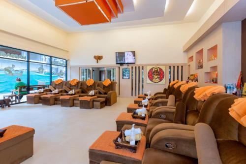 a large living room with couches and chairs at The Golden Ville Boutique Hotel and Spa in Pattaya Central