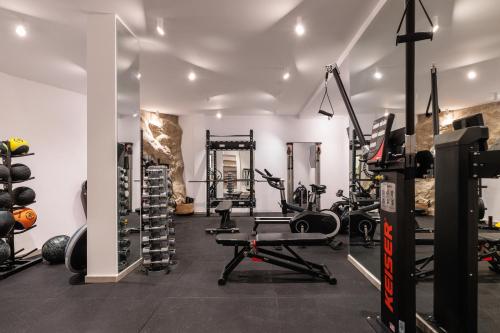 a gym with tread machines and weights in a room at Mileo in Kalo Livadi