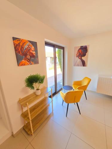 a living room with a table and a chair at Die Regte Rede in Cape Town