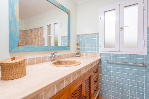 a bathroom with a sink and a mirror at Can Boi Den Cifre in Pollença