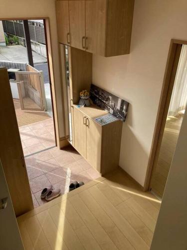 a small kitchen with a counter and some shoes on the floor at Disney11min Makuhari Messe14min 2 free parking in Funabashi
