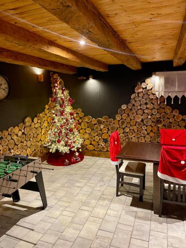 a room with a christmas tree and a ping pong table at Holiday Home Zagorka in Ogulin