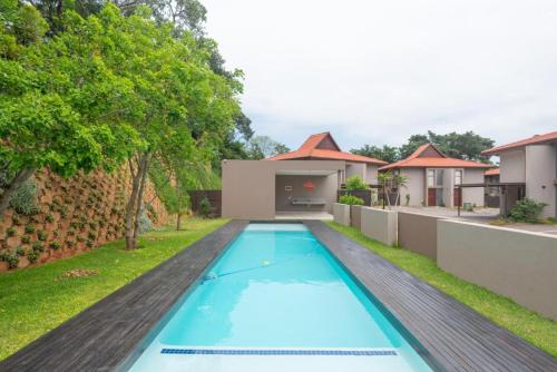 an image of a swimming pool in the backyard of a house at Stylish Ballito Home - Zimbali Wedge in Ballito