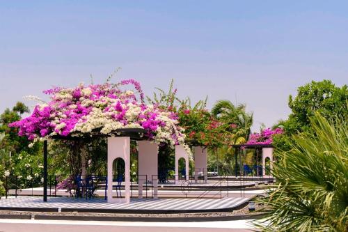 a pavilion with pink and white flowers on it at The Sea-Cret Garden Hua Hin in Hua Hin