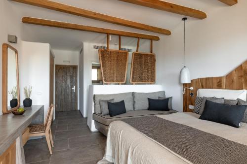a bedroom with a large bed and a table at Mileo in Kalo Livadi