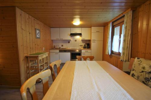 a kitchen with a long wooden table and chairs at Vendula Montafon in Partenen