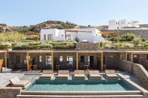 a villa with a swimming pool and a house at Mileo in Kalo Livadi