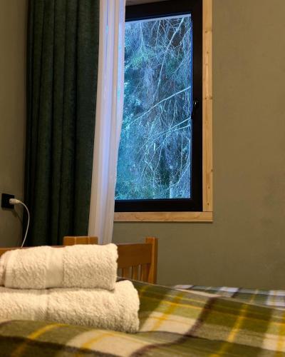 a bedroom with a bed and a window at In The Forest in Mestia