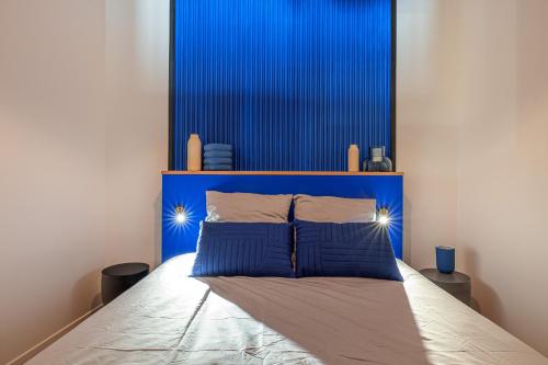 une tête de lit bleue avec deux oreillers bleus dans l'établissement Le Joyau 3 pièces au coeur de Nice, à Nice