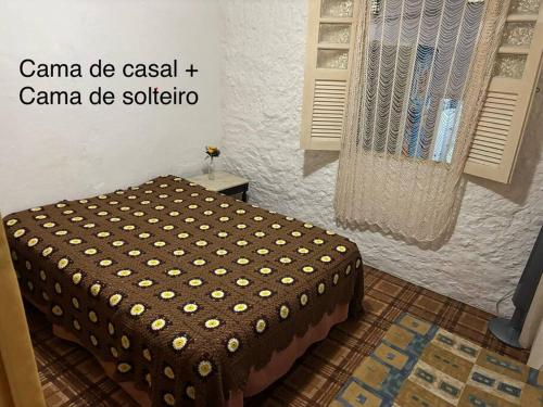 a bedroom with a bed in a room with a window at Casa ampla com vista para o mar in Mangaratiba