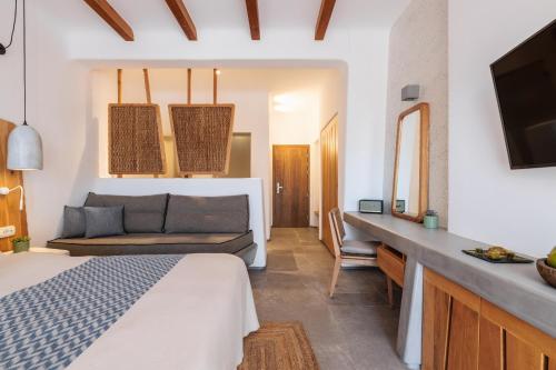 a bedroom with a bed and a couch at Mileo in Kalo Livadi