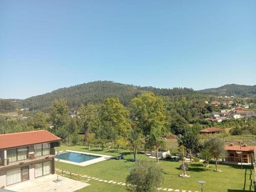 an aerial view of a house with a swimming pool at Dalpendre - Turismo em espaço rural in Felgueiras