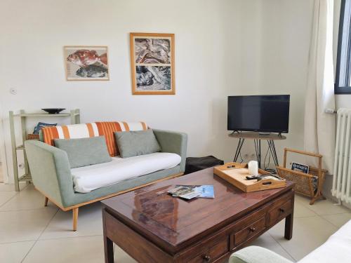 a living room with a couch and a coffee table at Kerastrobel in Crozon