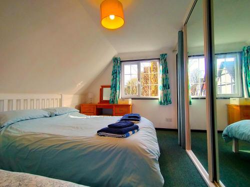a bedroom with a bed with blue towels on it at Tudor Cottage Hayle - a Family & Dog Favourite in Hayle