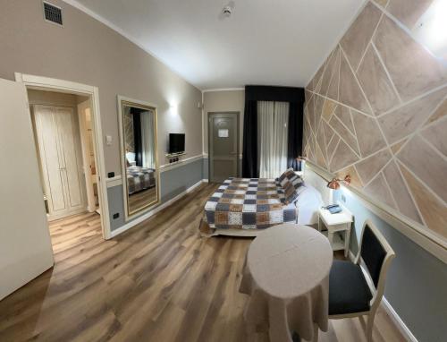 a bedroom with a bed and a table in a room at MOTEL Malpensa INN & Hotel-Airport in Tornavento