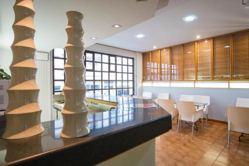 a dining room with a table and chairs at Hotel Alda Boiro in Boiro