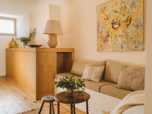 a living room with a couch and a painting on the wall at Le Saint Hubert in Saint-Saturnin-les-Apt