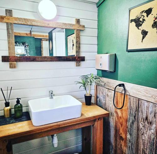 une salle de bain avec un lavabo blanc et un miroir dans l'établissement Yurt at Le Ranch Camping et Glamping, à Madranges