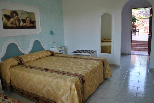 a bedroom with a large bed in a room at Hotel Ristorante Borgo La Tana in Maratea