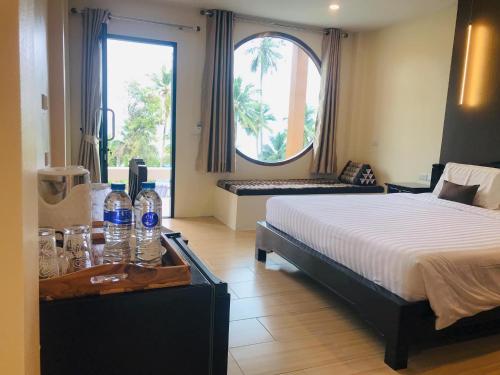 a bedroom with a bed and a table with bottles on it at Koh Yao Yai Sea Breeze House เกาะยาวใหญ่ซีบรีซเฮ้าส์ in Ko Yao Yai