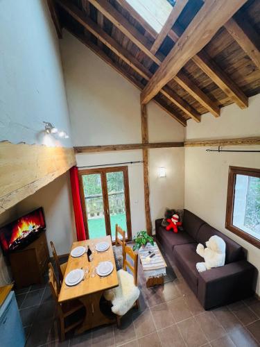 a living room with a couch and a table at Nordique Symbiose in Chapelle-des-Bois