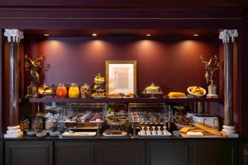 a display case with a bunch of pastries and desserts at UNE AUTRE CHAMBRE in Paris