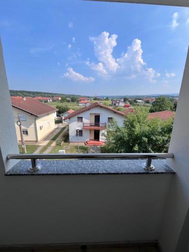 a window with a view of a house at Home sweet home in Petrovaradin