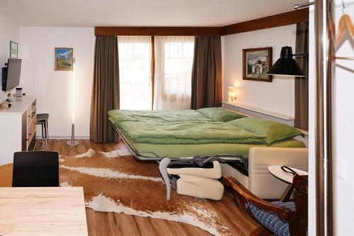 a bedroom with a bed and a desk at Chalet Valeria in Saas-Fee
