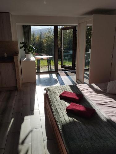 a bedroom with a bed with two red pillows on it at Cezar Naturyzm Bielsko-Biała in Bielsko-Biała
